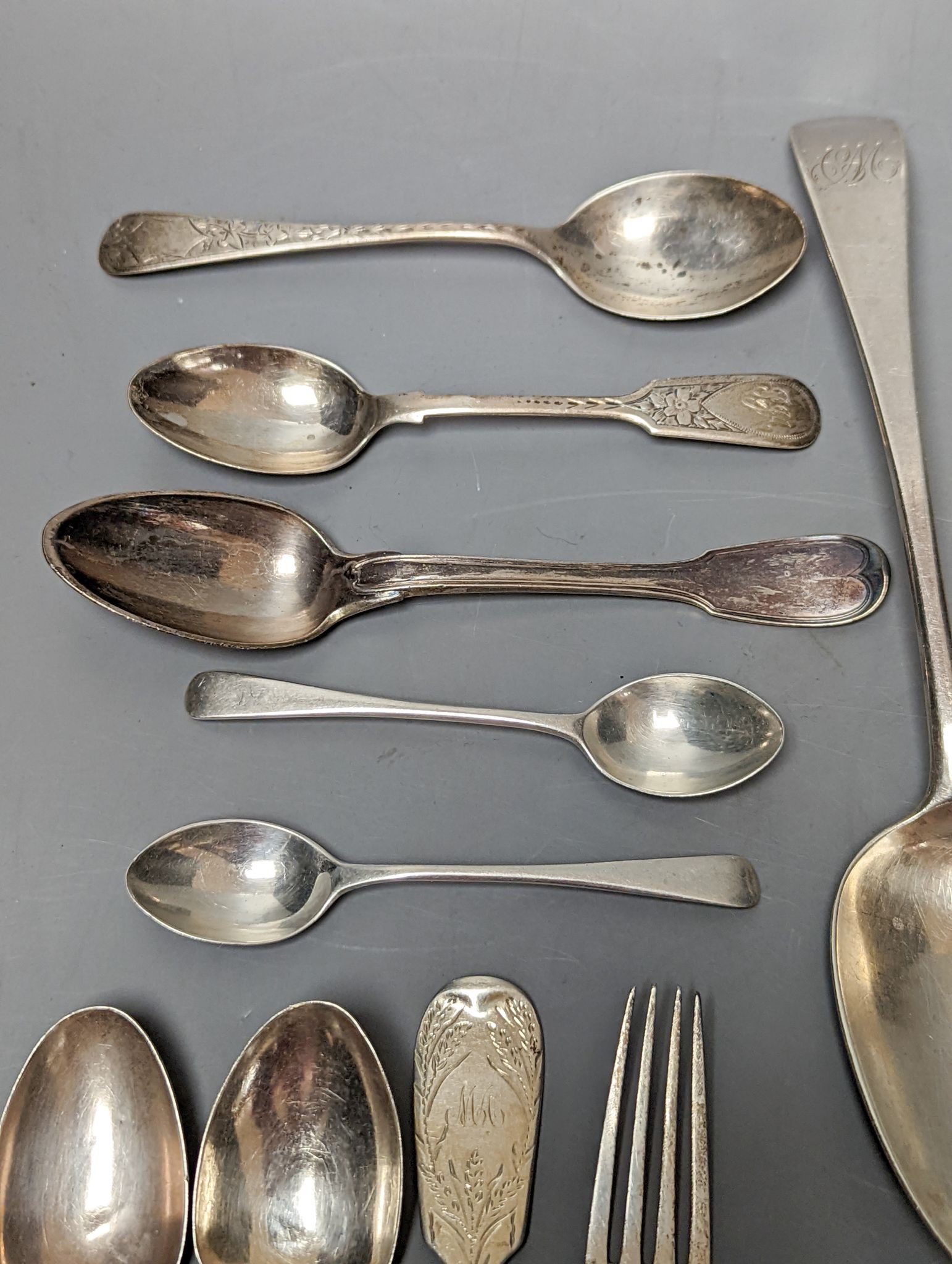 A small quantity of assorted mainly 19th century silver flatware including a pair of George III Old English pattern table spoons, Smith & Hayter, London, 1794 and a silver butter knife, 15oz